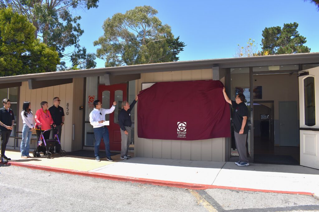 Gateway Center Pacific Grove sign unveiling with program participants, staff, and Board members